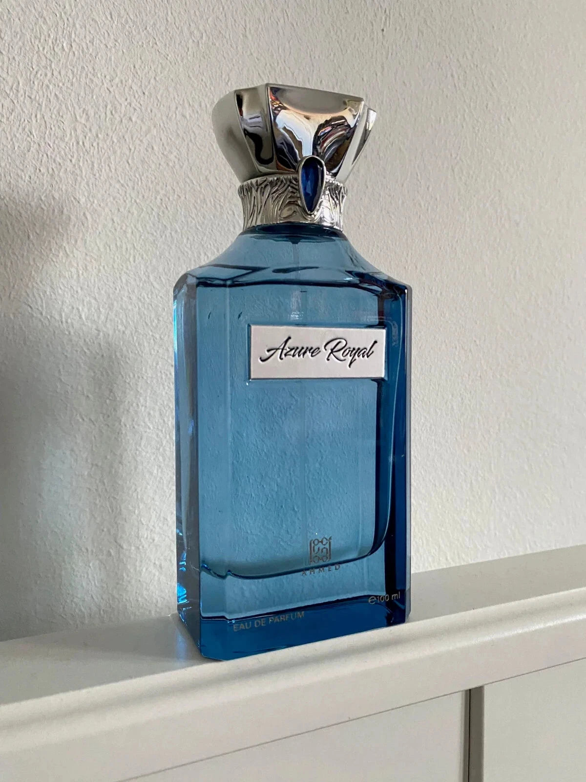 Ahmed Al Maghribi Azure Royal  Blue perfume bottle labeled 'Azure Royal' on a white surface with a light gray background