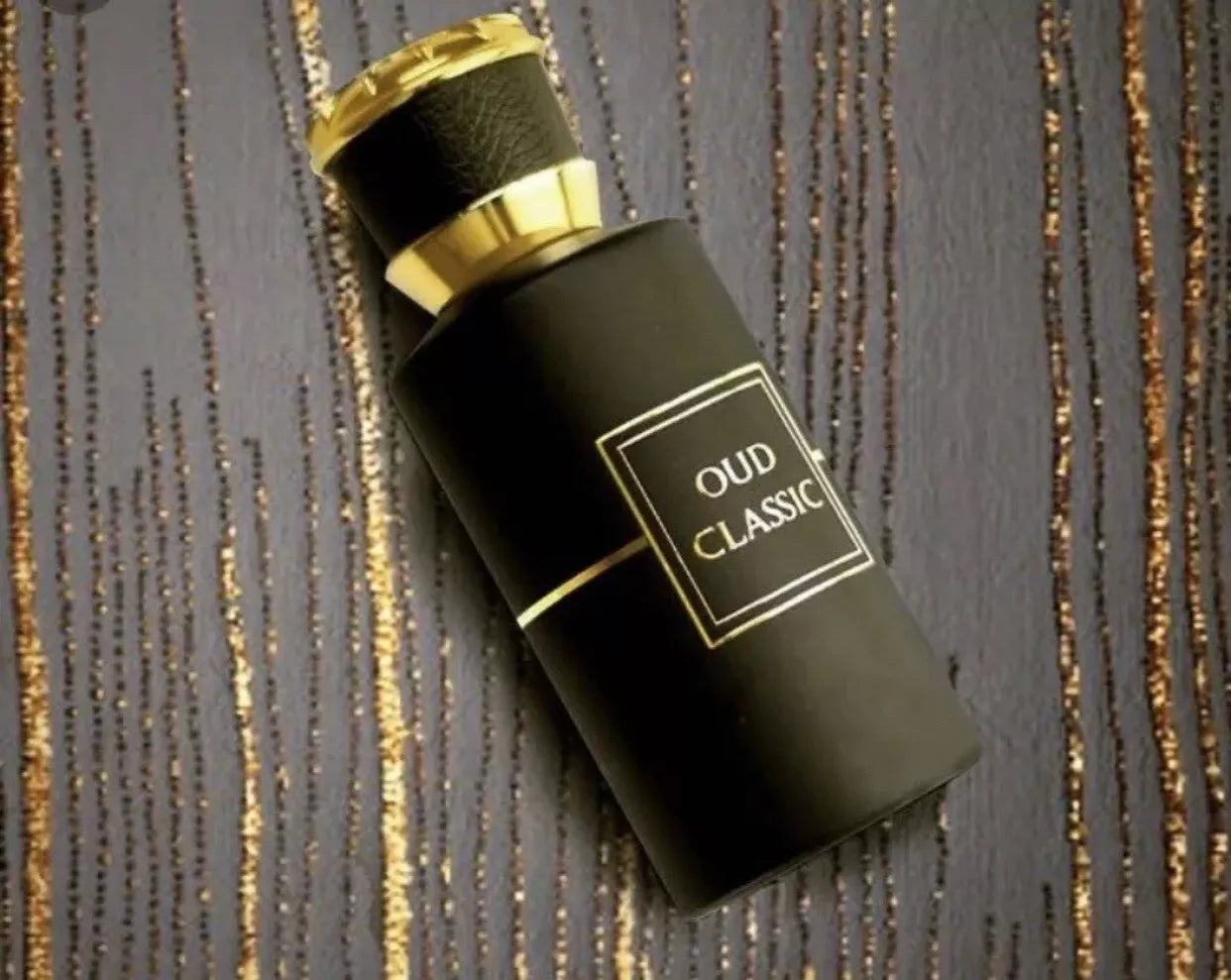 Ahmed Al Maghribi Oud Classic Black and gold perfume bottle labeled 'Oud Classic' on a textured background