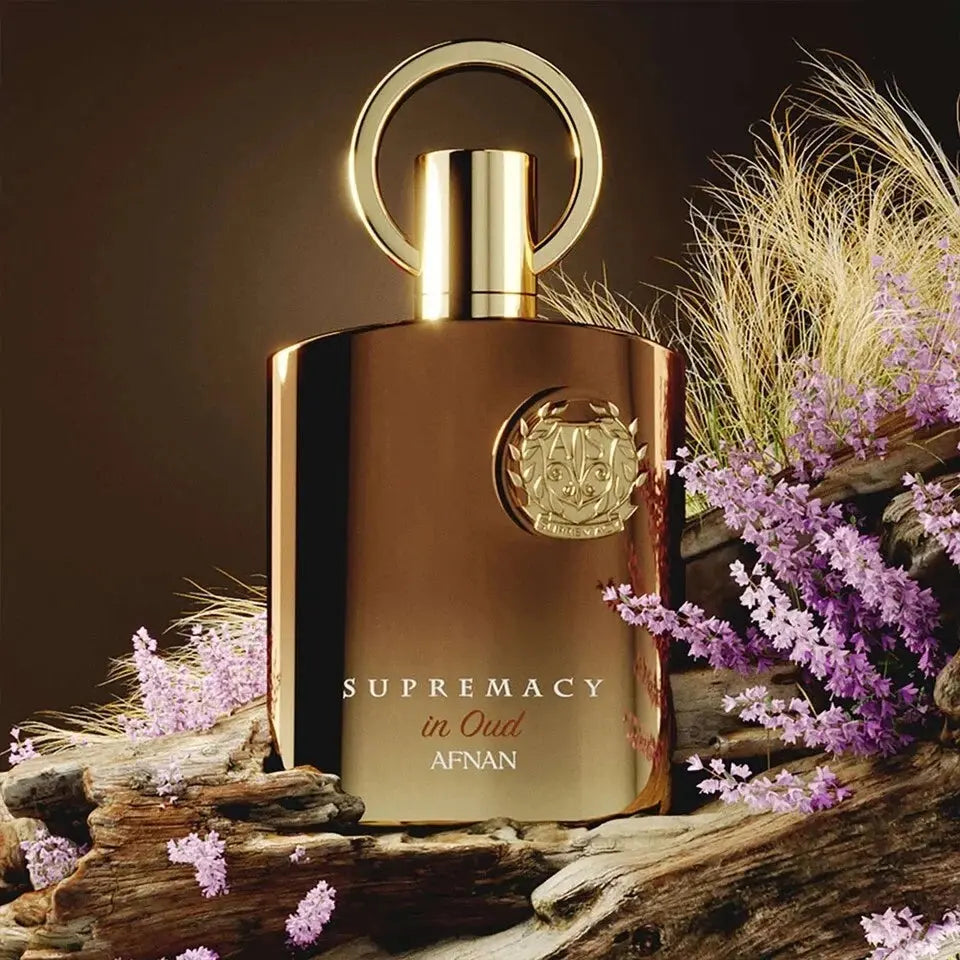 Perfume bottle labeled 'Supremacy in Oud' by Afnan with decorative elements on a dark background