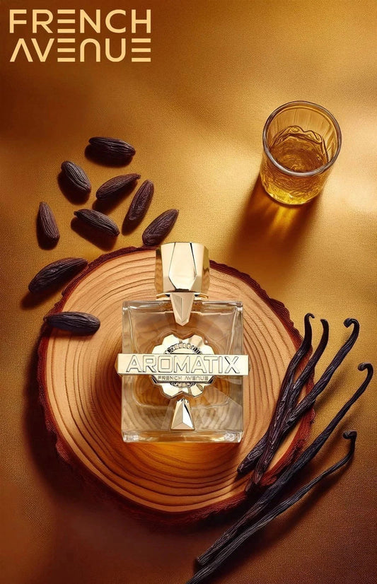 Aromatix perfume bottle on a wooden surface with vanilla beans and a glass of liquid, featuring the French Avenue brand.