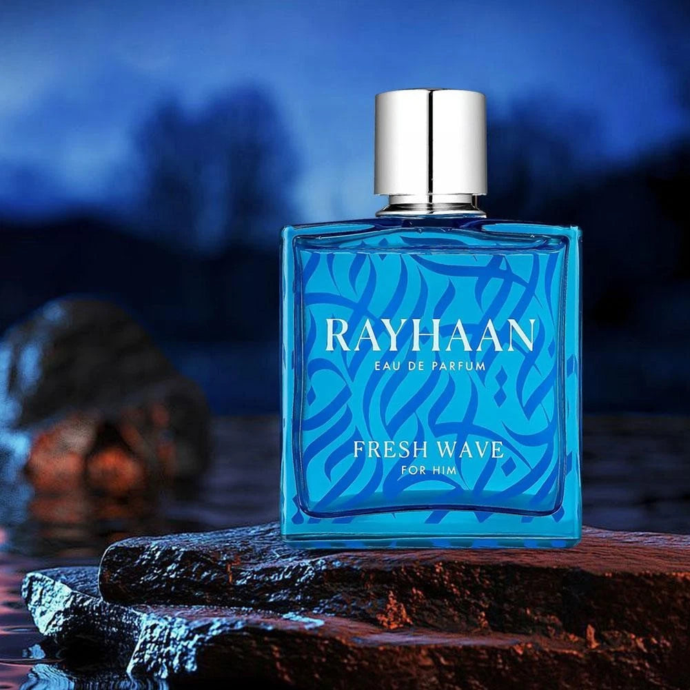 Rayhaan Fresh Wave Blue perfume bottle labeled 'RAYHAAN' on a wooden surface with a blurred natural background
