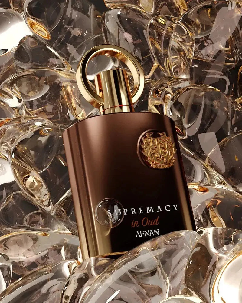 Perfume bottle labeled 'Supremacy in Oud' by Afnan on a decorative background
