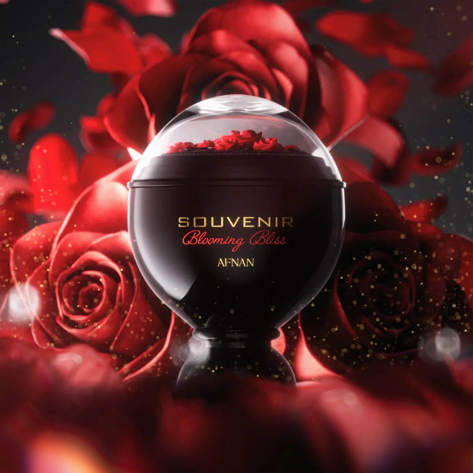 Black perfume bottle labeled 'Souvenir Blooming Bliss' by Afnan surrounded by red roses on a dark background.